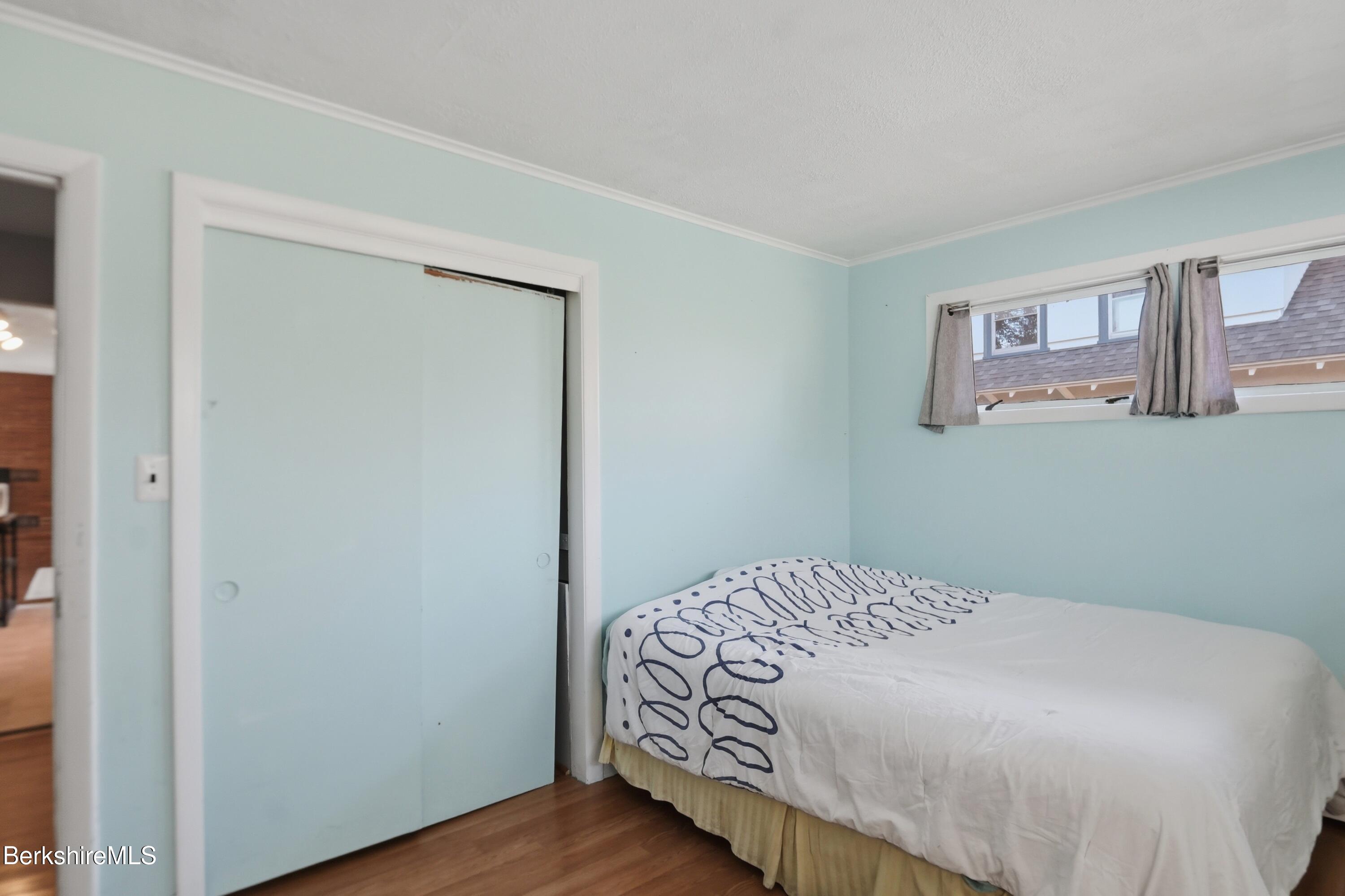 55 Tower Road Dalton, MA 01226 - Photo 22 of 47 a bedroom with a bed and wooden floor