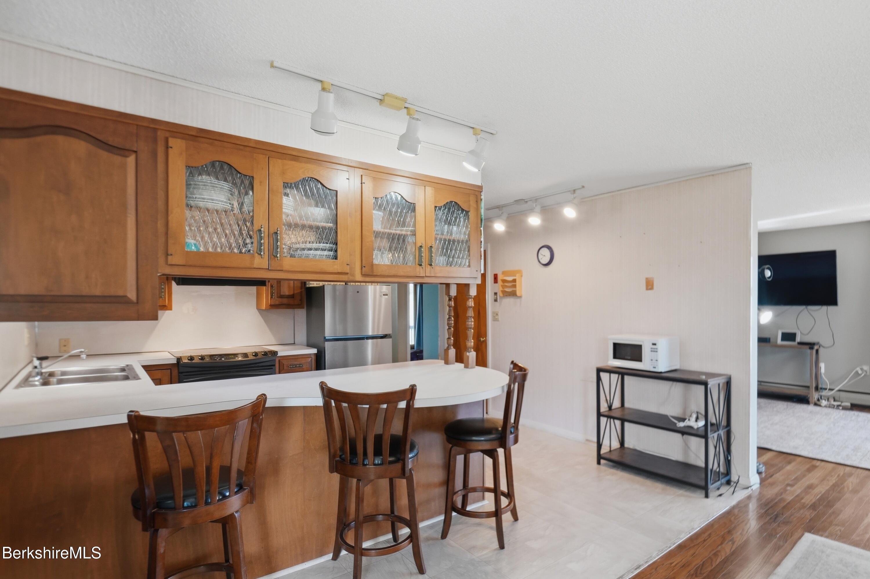 55 Tower Road Dalton, MA 01226 - Photo 4 of 47 a living room with stainless steel appliances kitchen island granite countertop furniture and a wooden floor