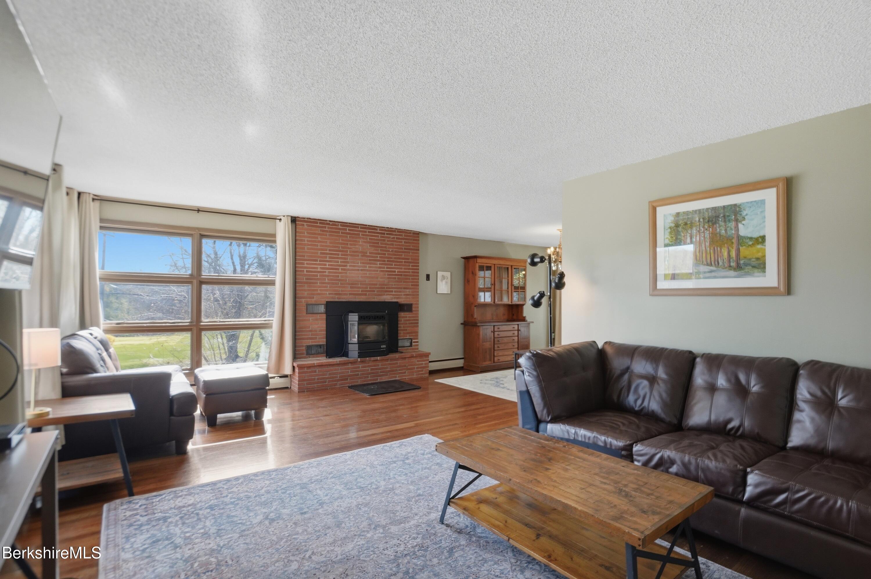 55 Tower Road Dalton, MA 01226 - Photo 8 of 47 a living room with furniture fireplace and a large window