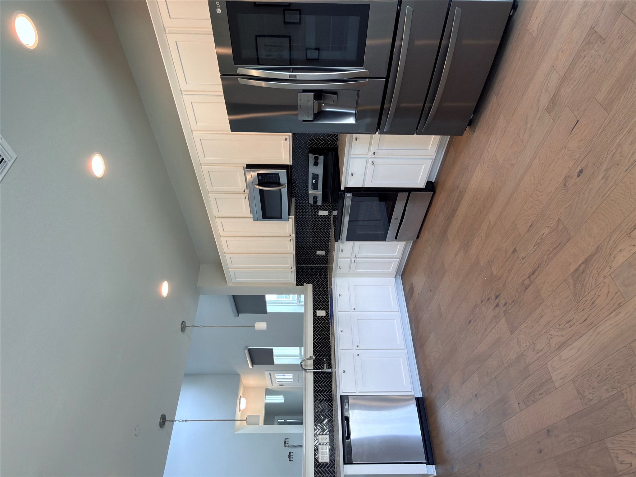 11216 Gadsen Lane Austin, TX 78754 - Photo 13 of 36 A well-appointed kitchen features stainless steel appliances and abundant white cabinetry, ready for culinary endeavors.