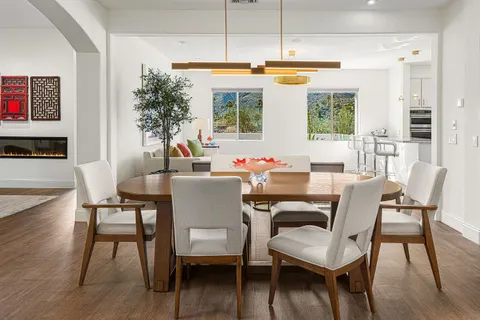 a kitchen with stainless steel appliances granite countertop a sink dishwasher and a stove with wooden floor