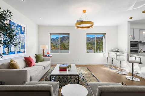 a room with a large window and dining table