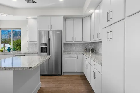 a living room with furniture cabinets and a flat screen tv