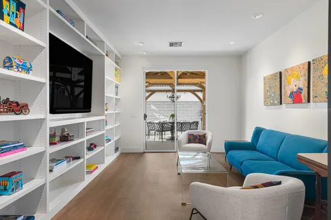 a view of a patio with couches table and chairs and potted plants