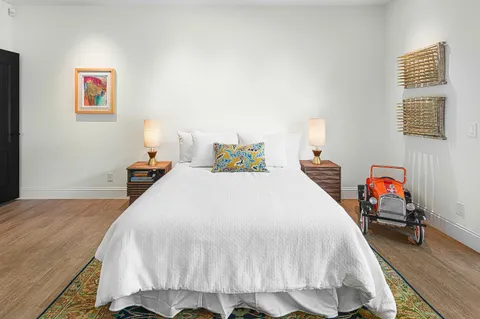 a bedroom with a large bed and a large window