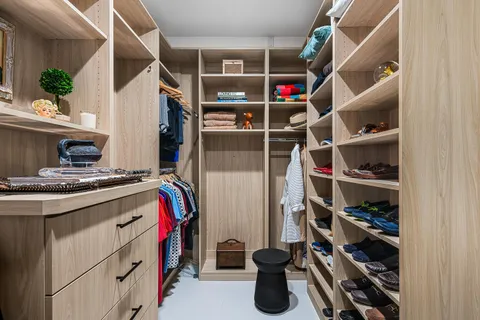 a bedroom with a bed and a lamp on the dresser