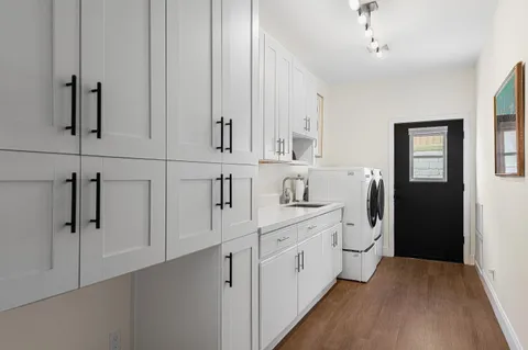a view of a dining room with furniture and a chandelier fan
