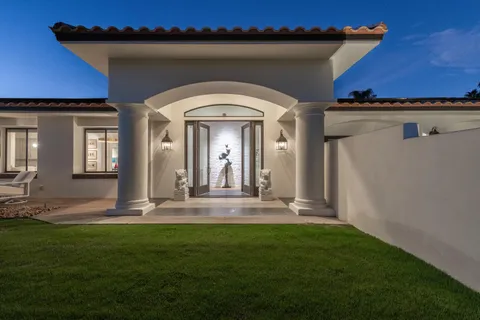a view of a patio with table and chairs with wooden floor and fence