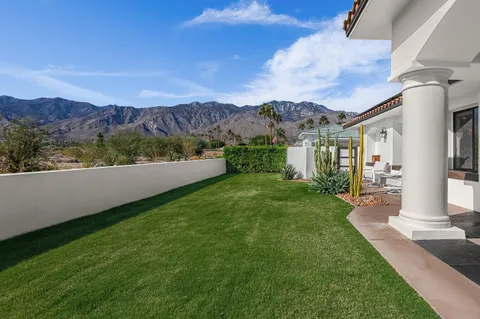 a dining room with furniture a chandelier and wooden floor