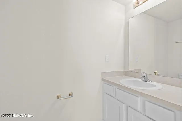 a bathroom with a sink a toilet and mirror