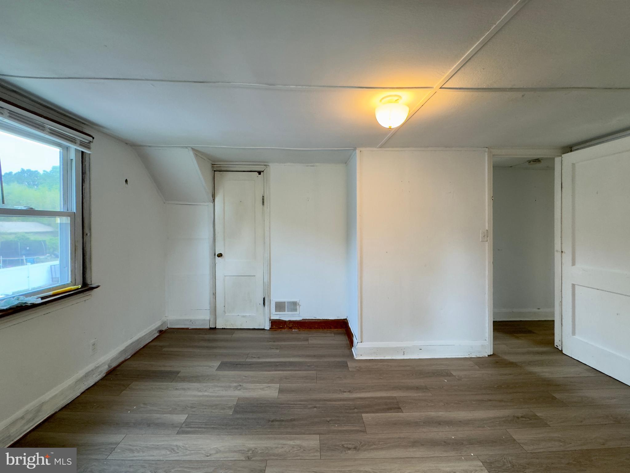 113 Rigdon Road, Unit 2 Aberdeen, MD 21001 - Photo 4 of 10 an empty room with wooden floor and windows