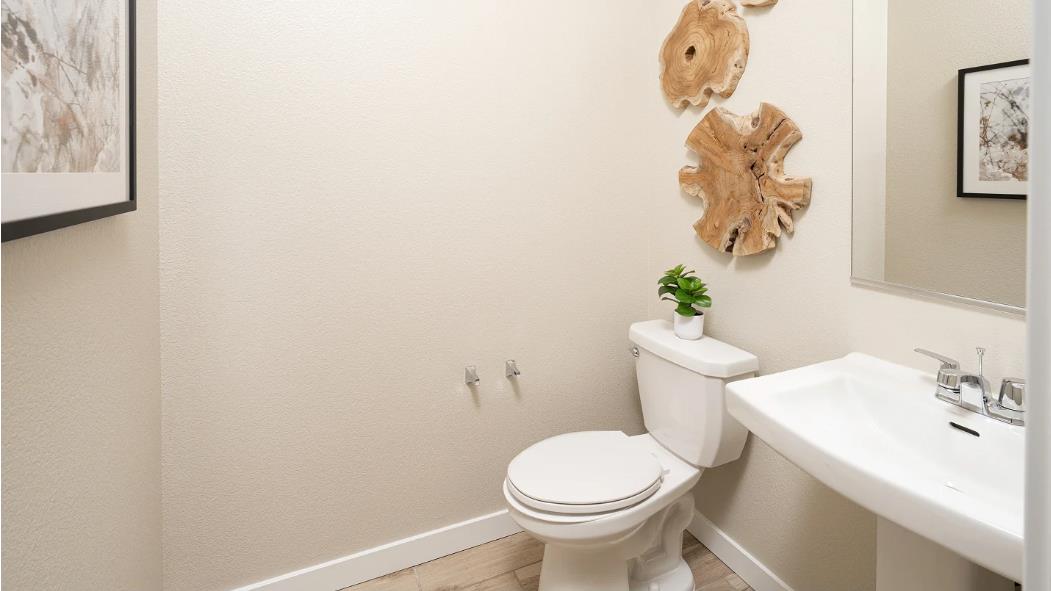 1156 Monique Street Galt, CA 95632 - Photo 7 of 17 a white toilet sitting next to a bathroom sink