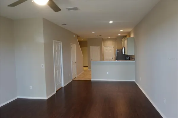 a view of a kitchen with a sink and a refrigerator