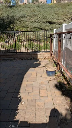 a swimming pool with outdoor seating and wooden fence