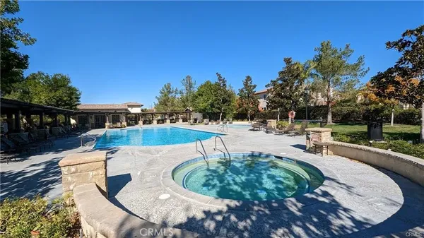 a view of a swimming pool with an outdoor space and seating area