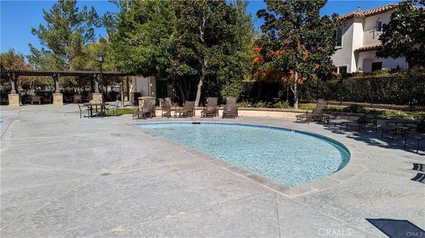 a view of a house with a yard and potted plants