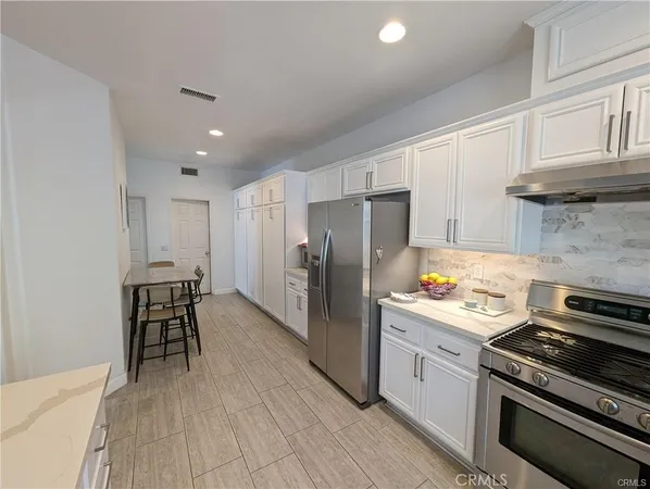a kitchen with a stove a sink and a refrigerator