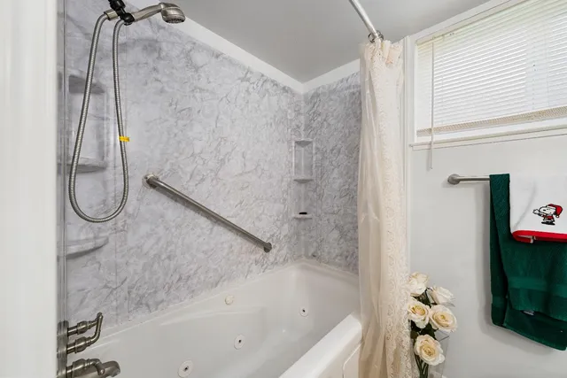 a bathroom with a shower and a shower
