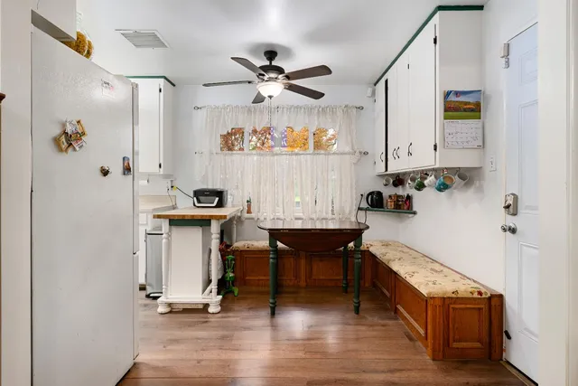 a view of hall way with furniture and wooden floor