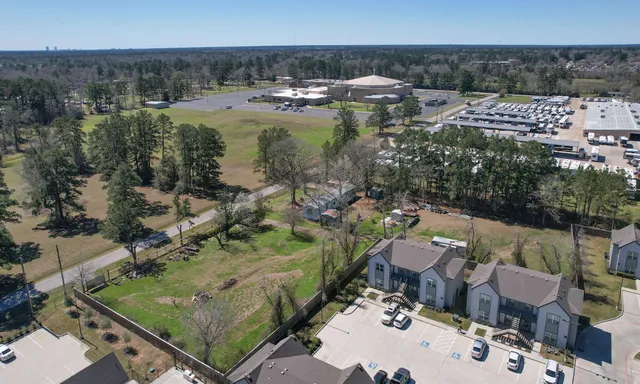 an aerial view of a house with a yard