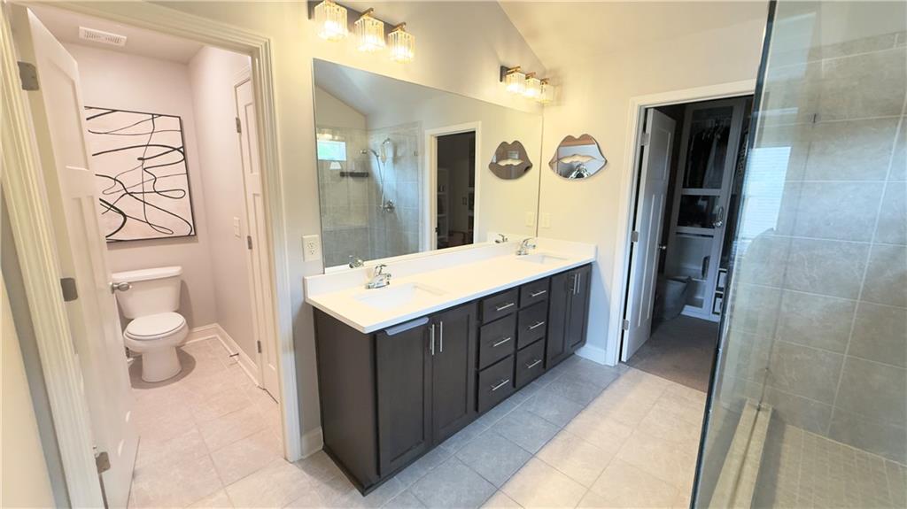 3370 Elkhorn Ridge Run Dacula, GA 30019 - Photo 7 of 29 a bathroom with a double vanity sink and mirror