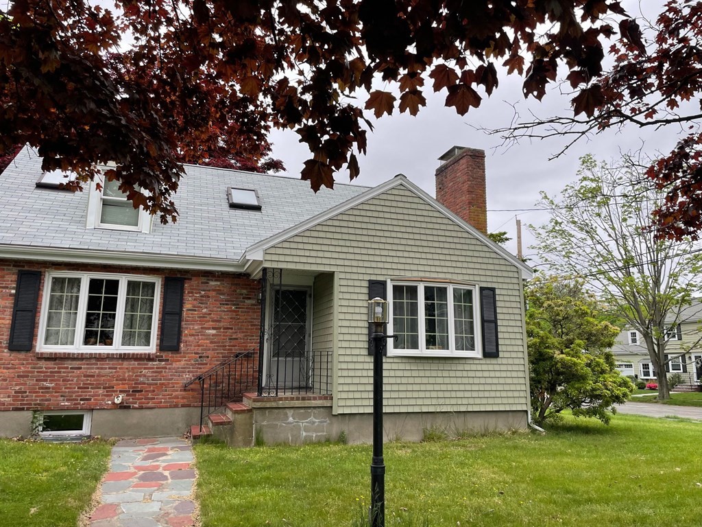 16 Coolidge Road Milton, MA 02186 - Photo 1 of 24 a front view of a house with a garden