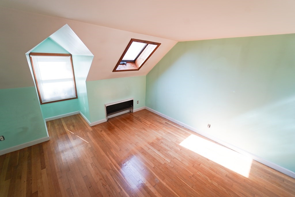 16 Coolidge Road Milton, MA 02186 - Photo 13 of 24 an empty room with wooden floor and windows