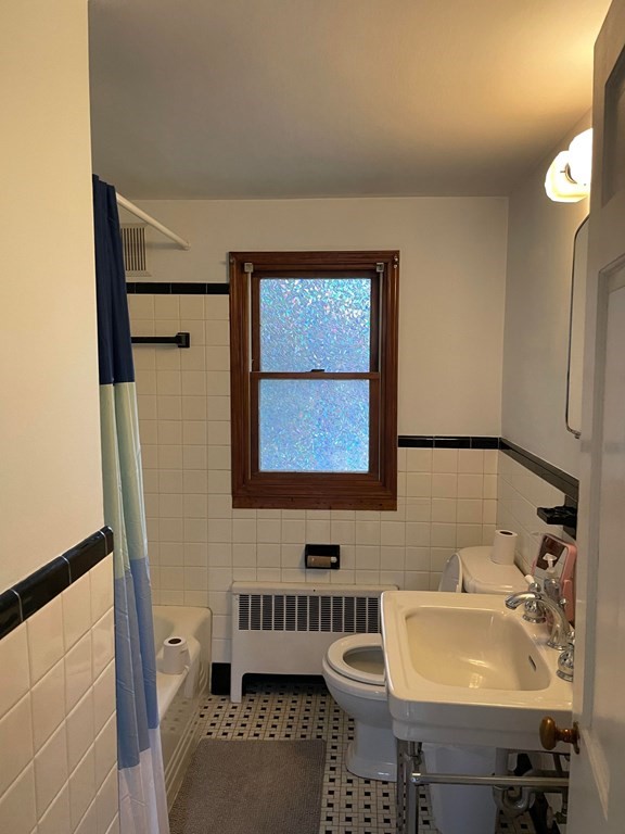 16 Coolidge Road Milton, MA 02186 - Photo 8 of 24 a bathroom with a sink a toilet and mirror