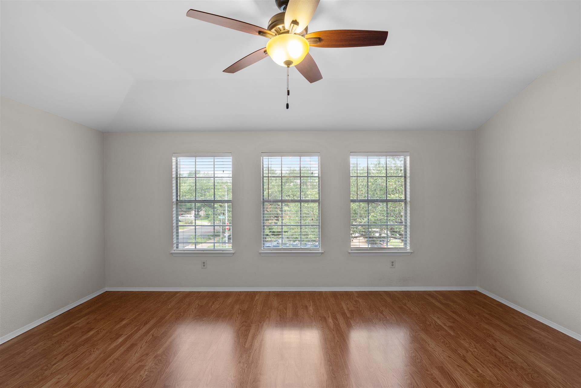 1710 Persimmon Road Cedar Park, TX 78613 - Photo 18 of 33 Multiple windows illuminate this inviting large primary bedroom featuring a ceiling fan for comfort.