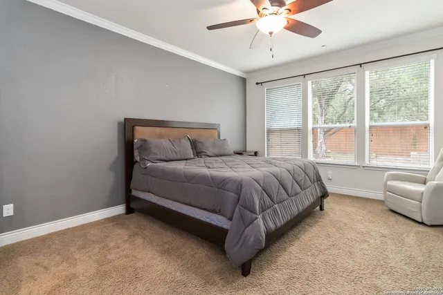 a bedroom with a bed couch and window