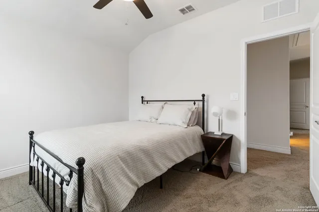 a bedroom with a bed and a night stand