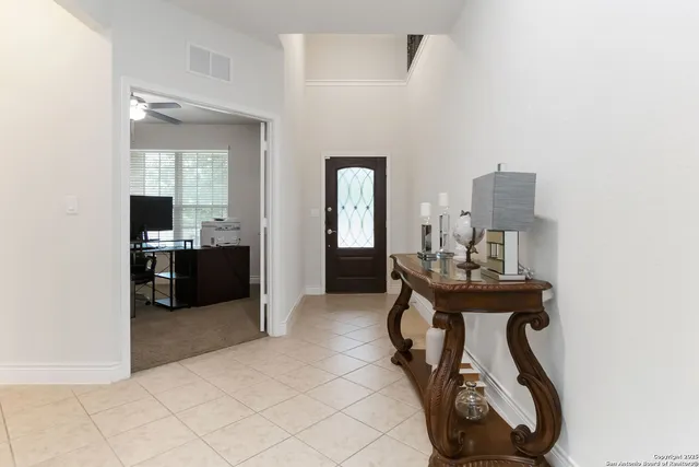 a view of a hallway with entryway and livingroom