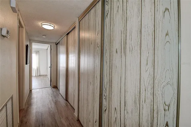 a bedroom with a large bed and wooden floor