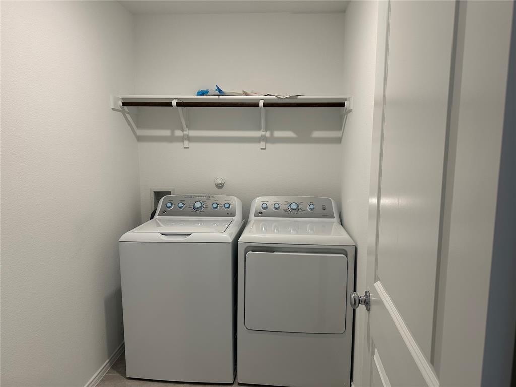 1729 High Perch Lane Forney, TX 75126 - Photo 12 of 16 Laundry area featuring washer and clothes dryer and baseboards