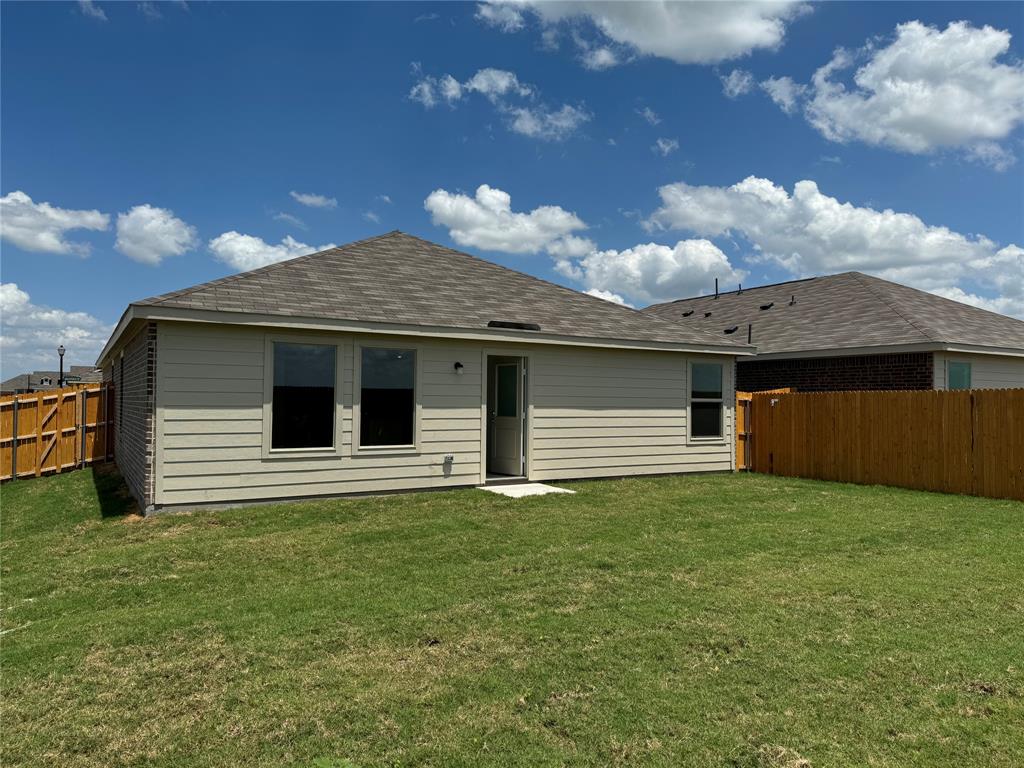 1729 High Perch Lane Forney, TX 75126 - Photo 13 of 16 Back of house featuring a shingled roof and a fenced backyard