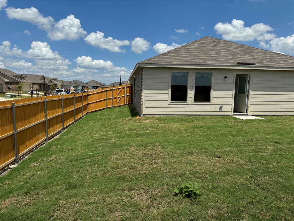 1729 High Perch Lane Forney, TX 75126 - Photo 14 of 16 Rear view of house featuring roof with shingles, a residential view, and a fenced backyard