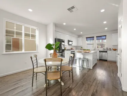 a view of a dining room with furniture and wooden floor
