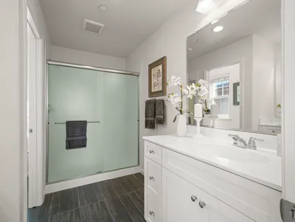 a bathroom with a sink vanity and mirror