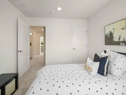 a bedroom with a bed and a painting on the wall