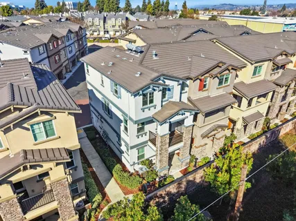 an aerial view of a house with a swimming pool and outdoor seating