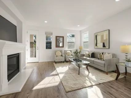 a living room with furniture large window and a fireplace