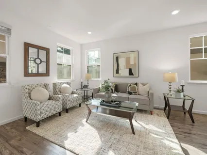 a living room with furniture and painting on the wall