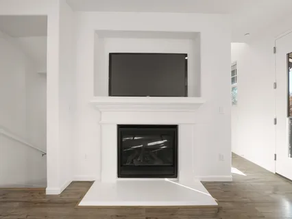 a living room with a fireplace and a wooden floor