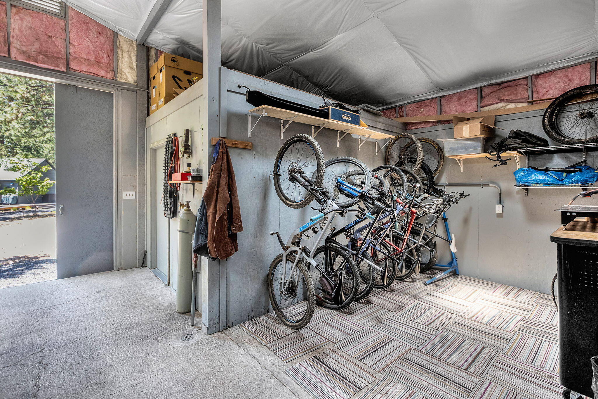 60210 East Ridgeview Drive Bend, OR 97702 - Photo 36 of 55 a view of a garage with rack and white walls