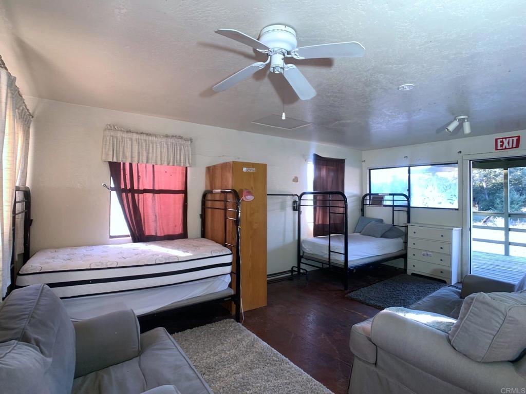 24352 Featherstone Canyon Road Lakeside, CA 92040 - Photo 26 of 75 a bedroom with furniture and wooden floor