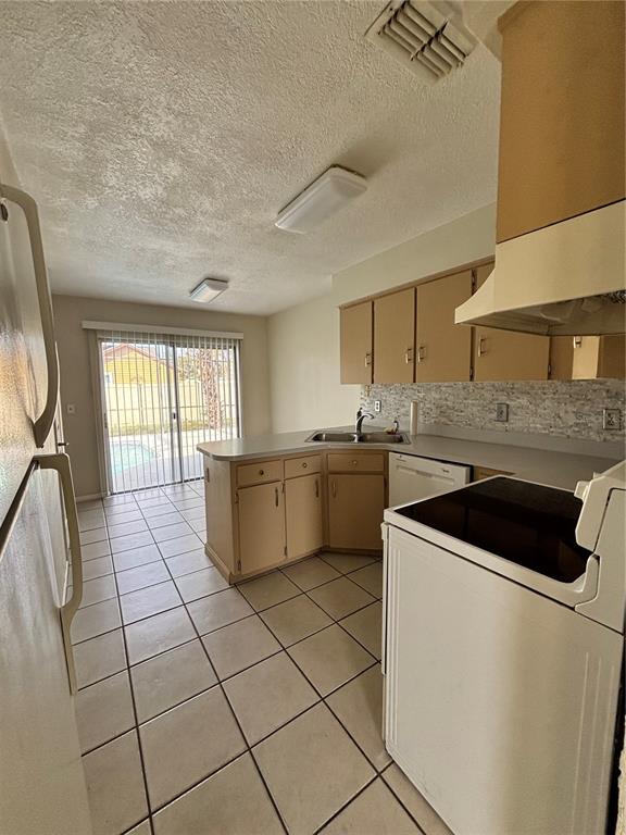2346 St Croix Street Kissimmee, FL 34741 - Photo 5 of 12 a kitchen with a sink a stove cabinets and a window
