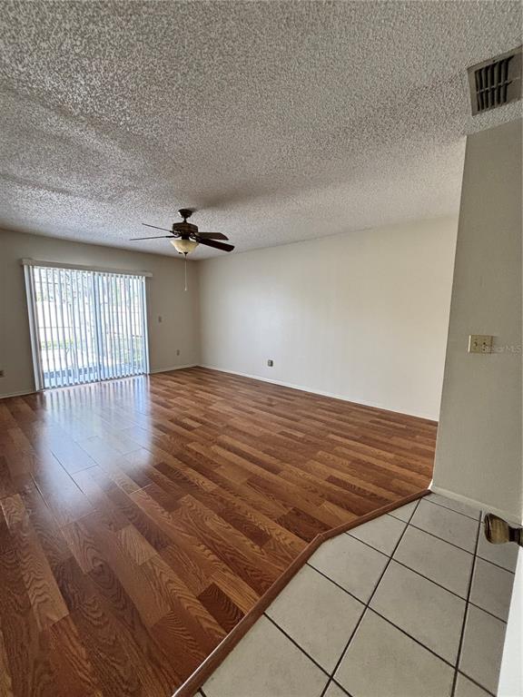 2346 St Croix Street Kissimmee, FL 34741 - Photo 7 of 12 wooden floor in an empty room with a window