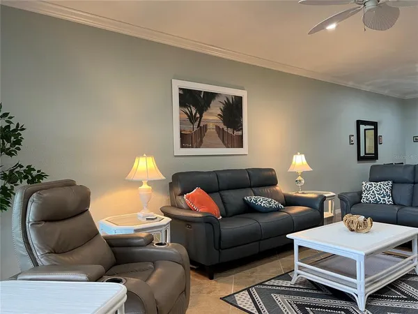 a living room with furniture a rug and a chandelier