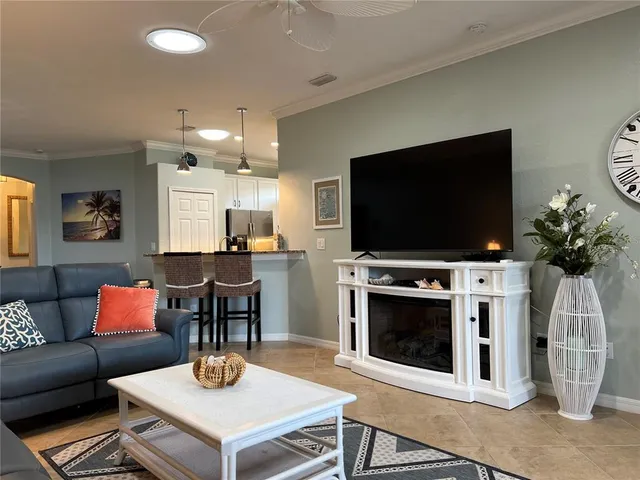 a living room with a couch and a view of kitchen