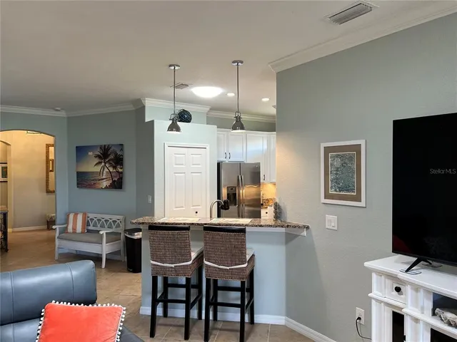 a view of a dining room with furniture and window